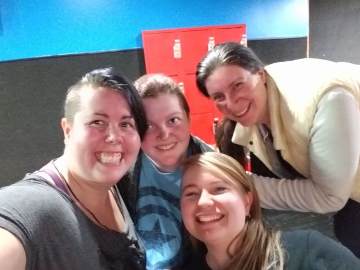 Four women smiling after completing their first roller derby practice.